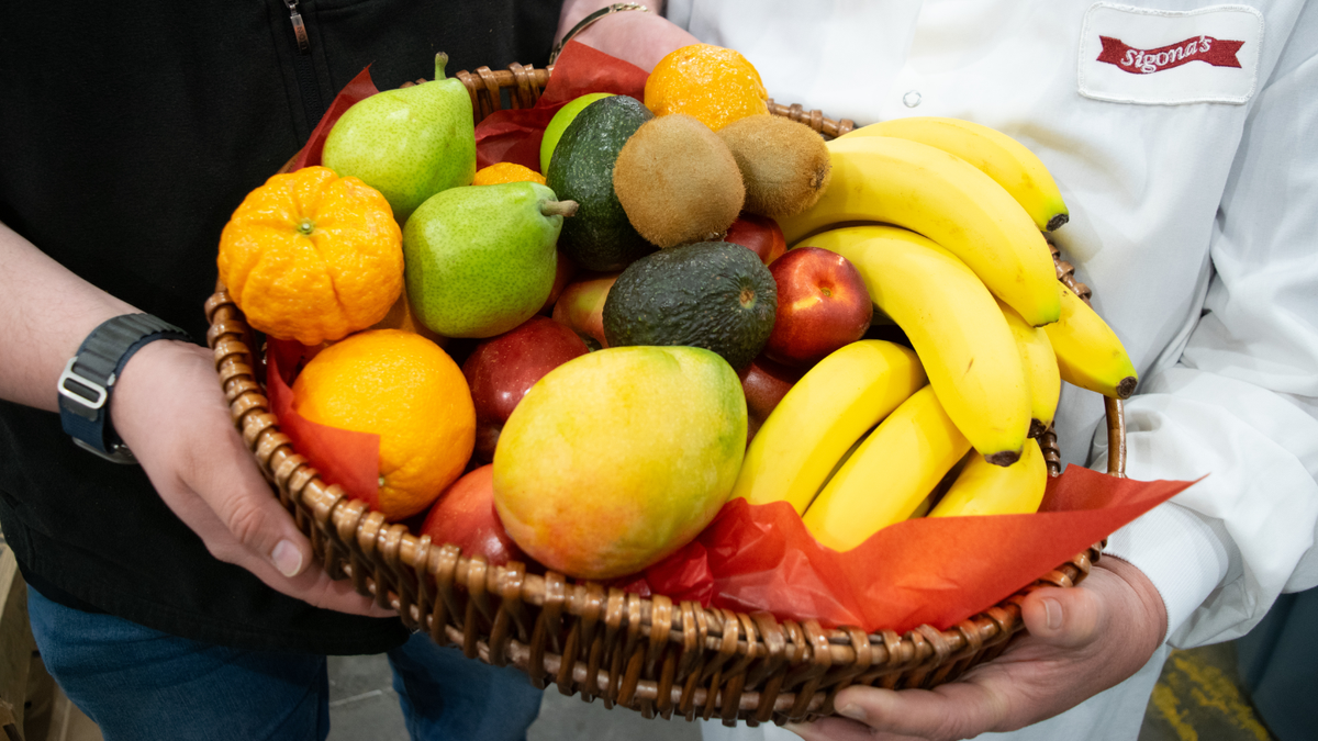 Hands holding fruit basket